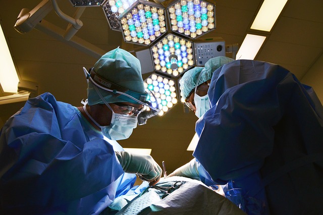 a surgeon with his partner perfoming an operation