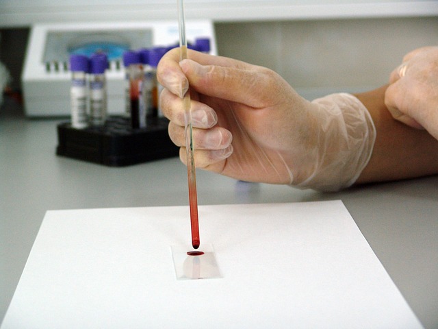 a person putting a blood sample on a microscope slide
