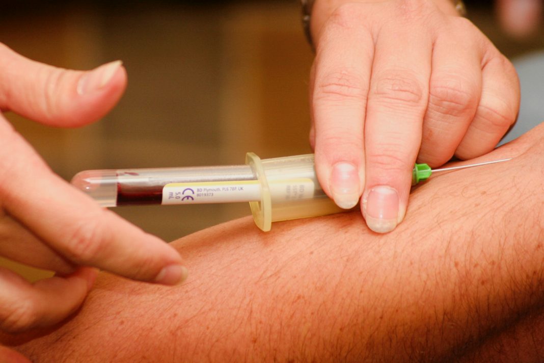 a person taking blood sample